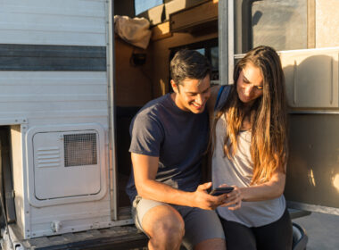 A couple using RVparky on their phone to find their next RV park