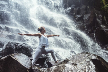 Woman doing yoga in front waterfall in New Hampshire
