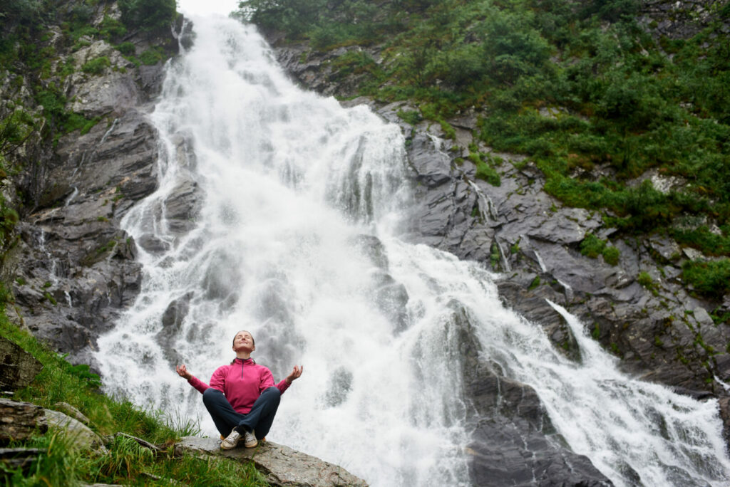 Woman standing in front of waterfall in New Hampshire