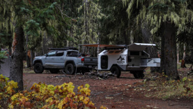 A mammoth overland trailer attached to a truck at a campground