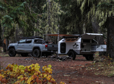 A mammoth overland trailer attached to a truck at a campground