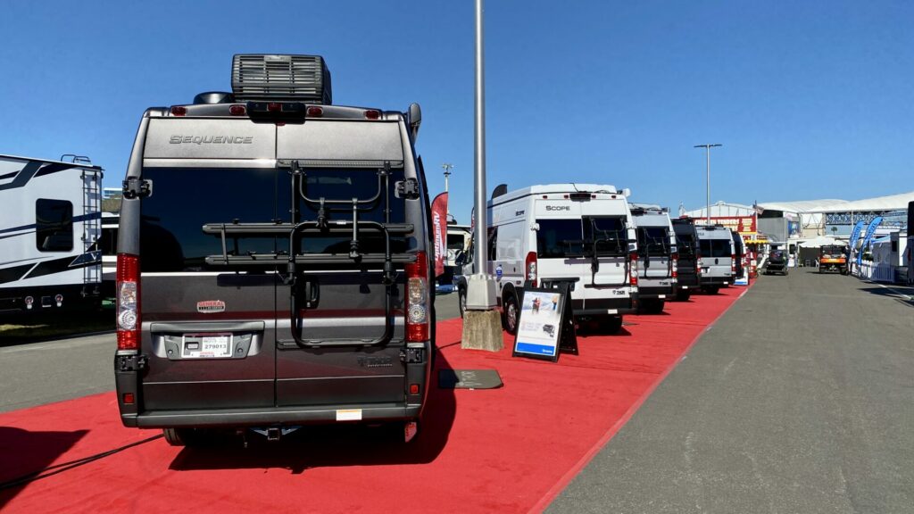 A row of Class B RVs at an RV show. Knowing how to negotiate RV price can help you take one of these home that's in your price range. 