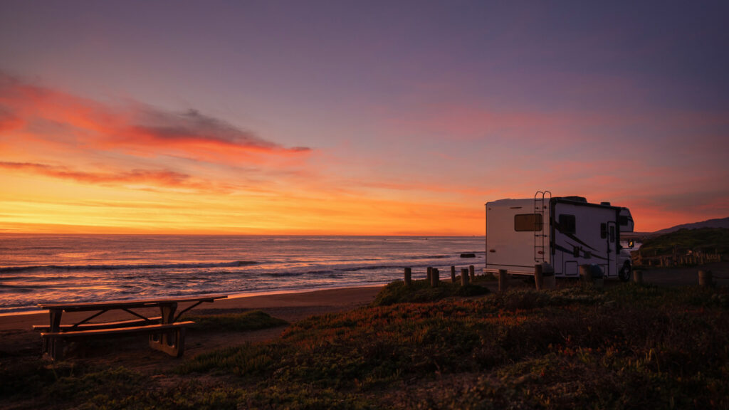 An RV parked by the beach boondocking