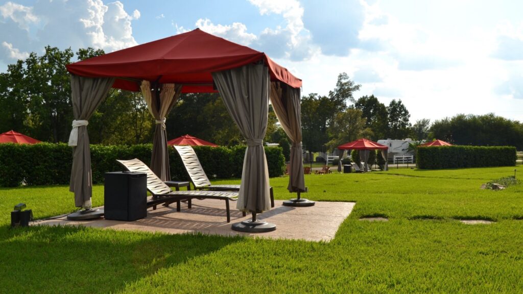 A photo of the cabanas and lounge chairs, located at the thousand trails lake conroe pool area. 