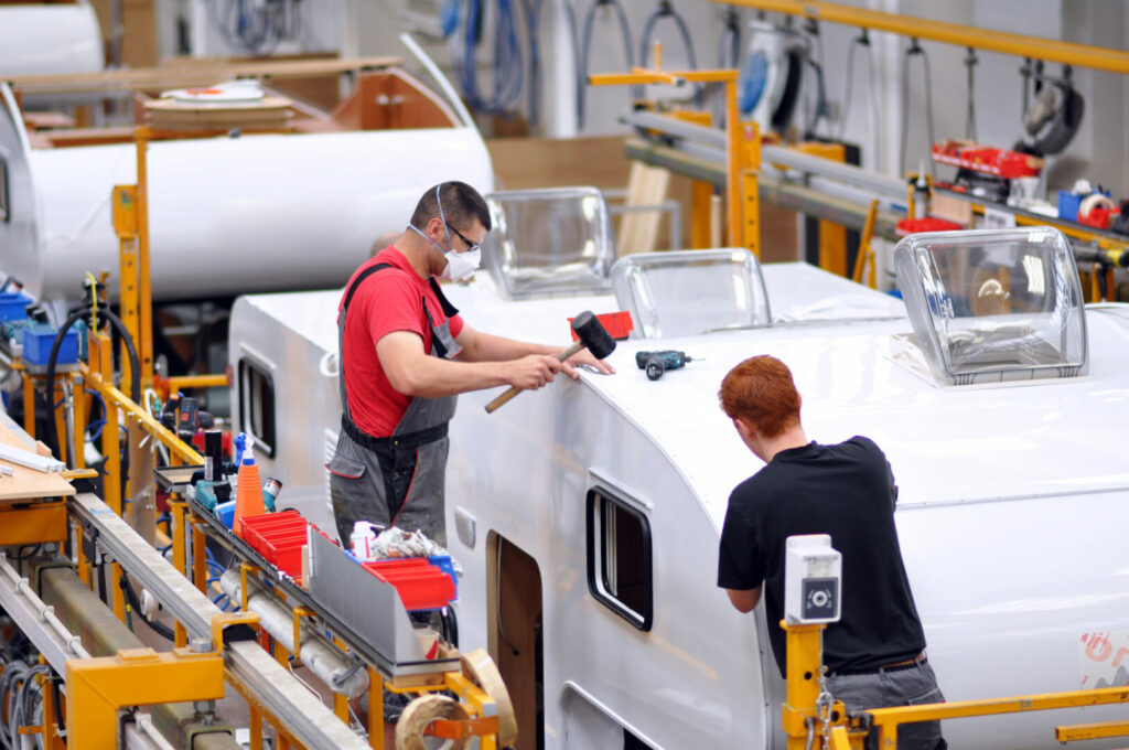 Employees working in a motorhome manufacturer factory