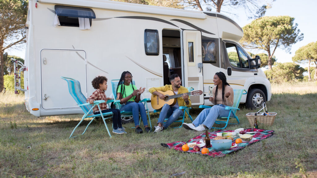 A family singing outside of their covid camper
