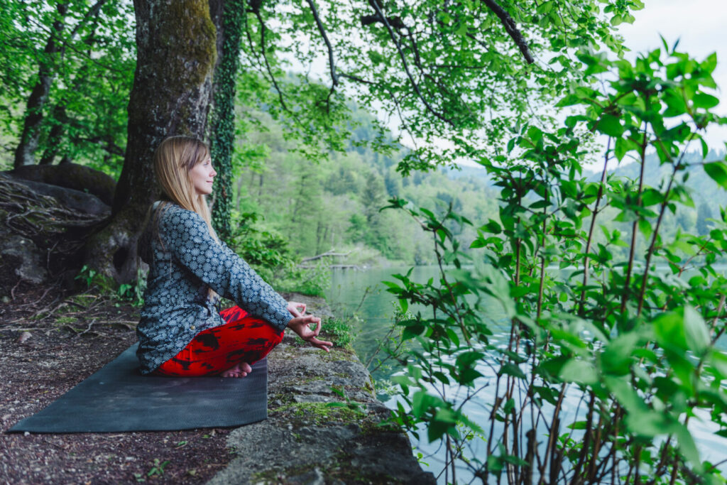 Women meditating in forest in upstate New York