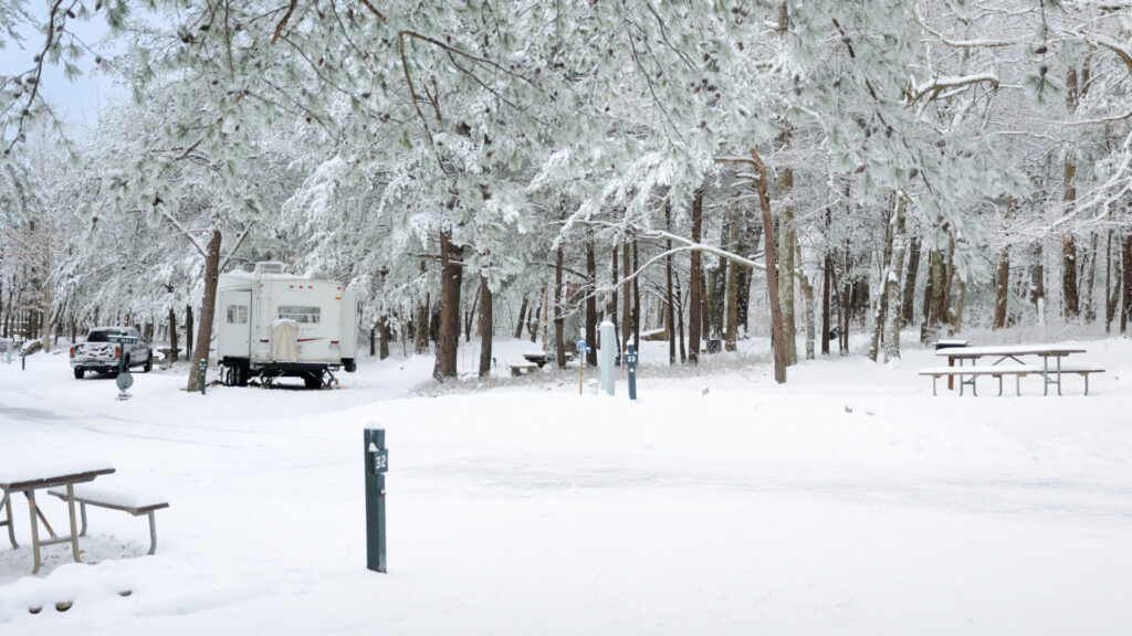 An RV parked at a campground in the winter