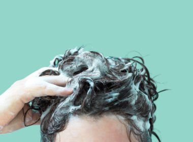 A person washing their hair during a navy shower