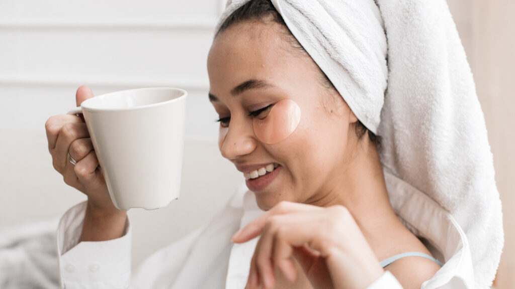 A woman drinking coffee while getting ready after her navy shower