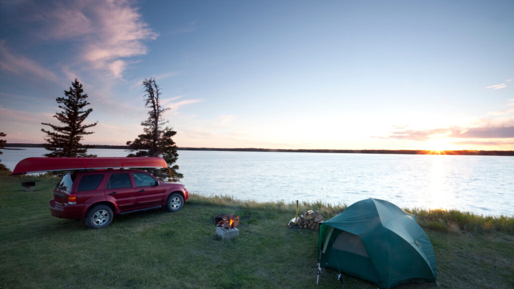View of a campsite set up by a lake in Riding Mountain National Park