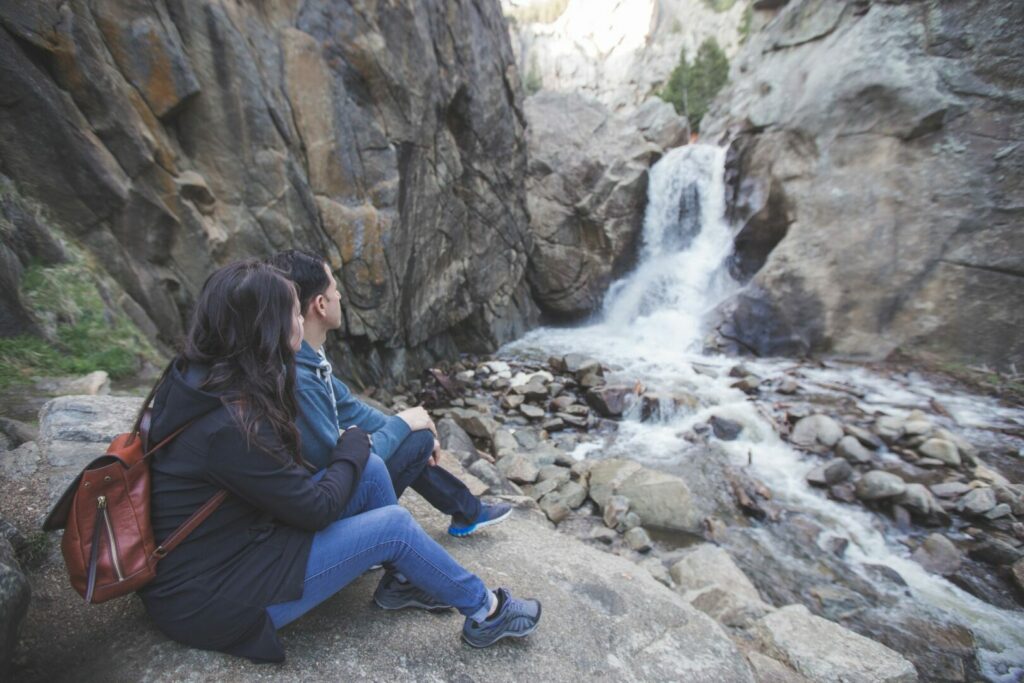 Couple looking at epic waterfall in Colorado