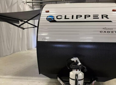 A Coachmen Clipper parked inside a garage
