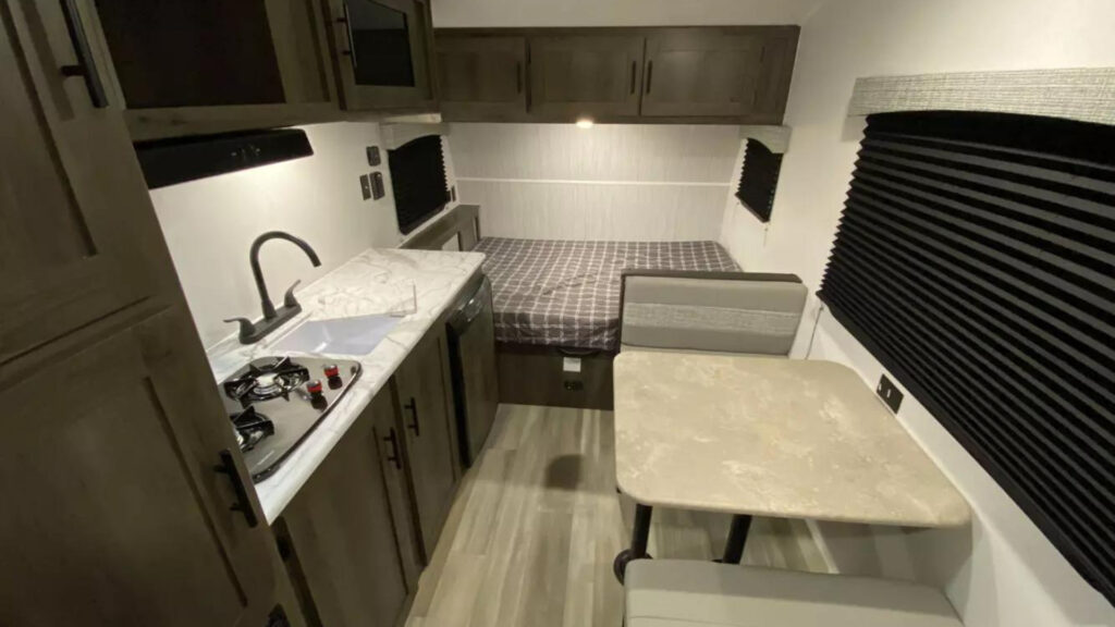The kitchen, dining area and bedroom area in a Coachmen Clipper 16CFB