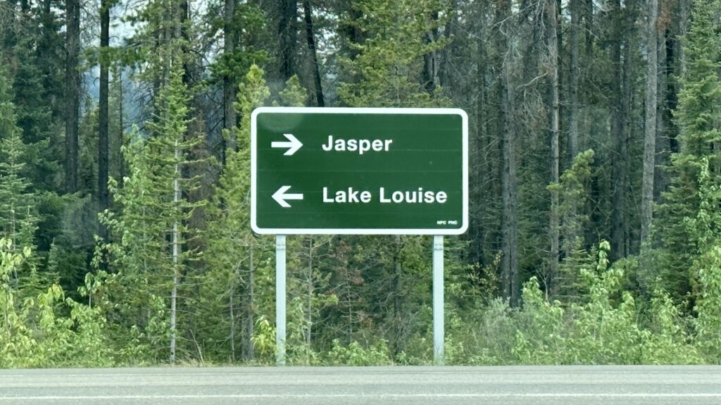 A road sign pointing to Jasper National Park and Lake Louise