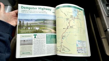A person holding a map of Demspter Highway
