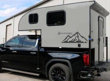 A soaring eagle truck camper attached to a pickup truck