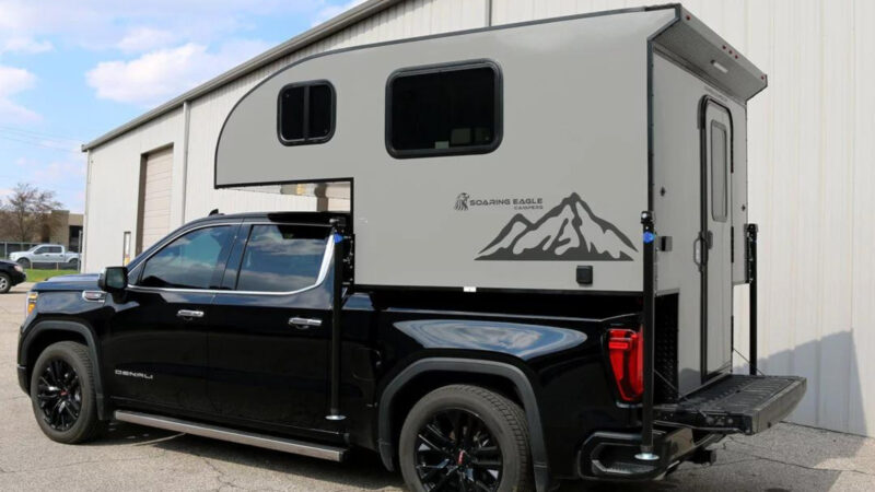 A soaring eagle truck camper attached to a pickup truck