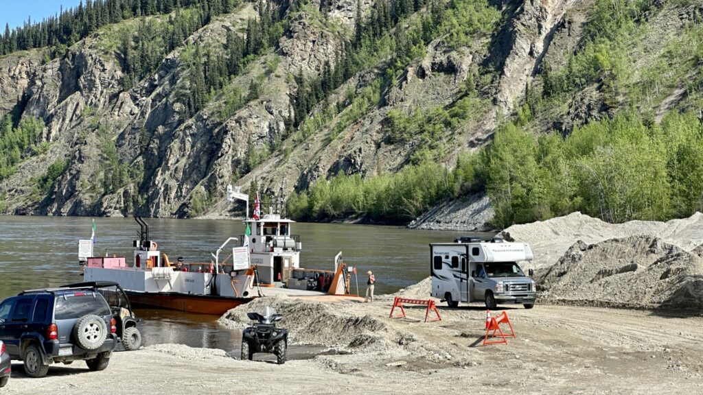 Cars parked by the Dawson City Ferry.