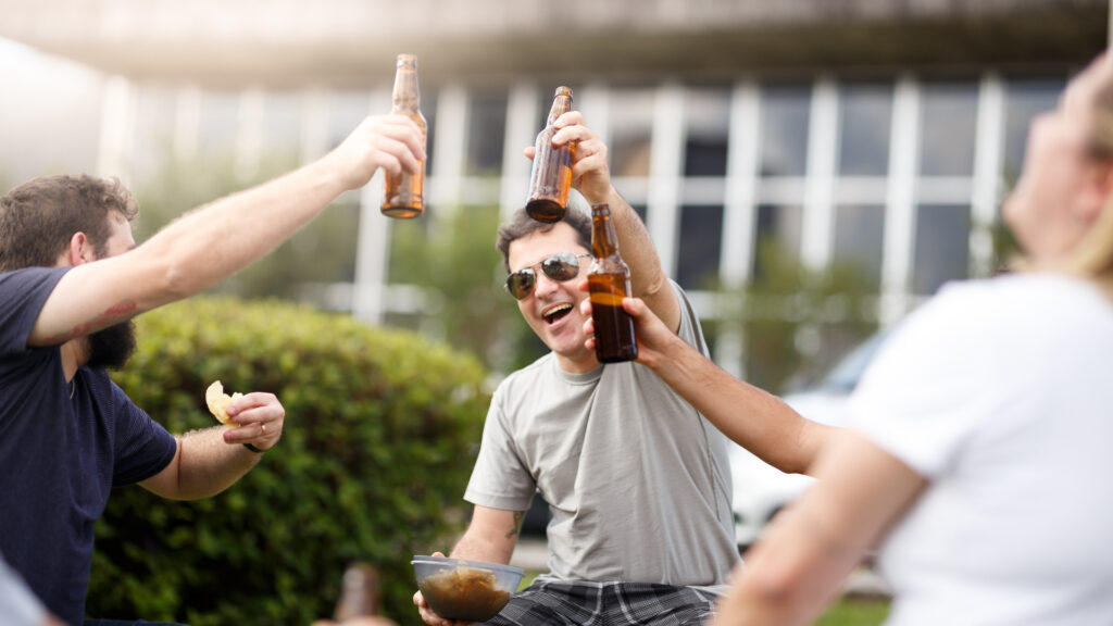 A group of friends drinking at a tailgating party.