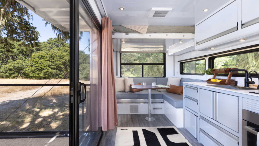 The kitchen and dining area inside a living vehicle.