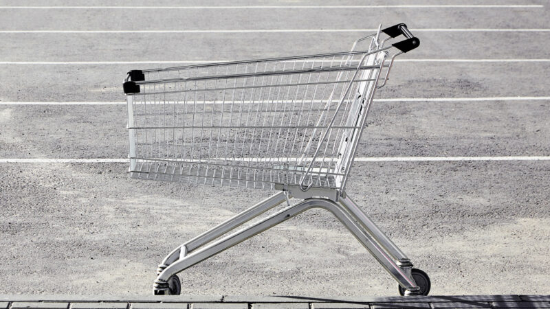 A shopping cart in a Walmart parking lot