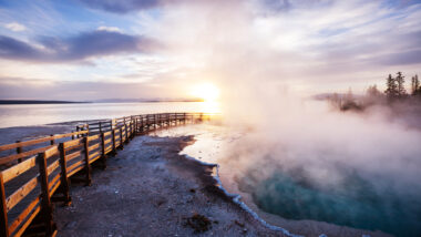 A boardwalk next to a geyser in Yellowstone National Park.