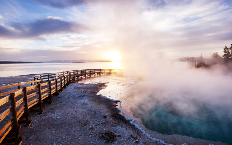 A boardwalk next to a geyser in Yellowstone National Park.