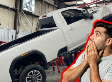 A man shocked to see a dropped truck off a lift at the mechanics.