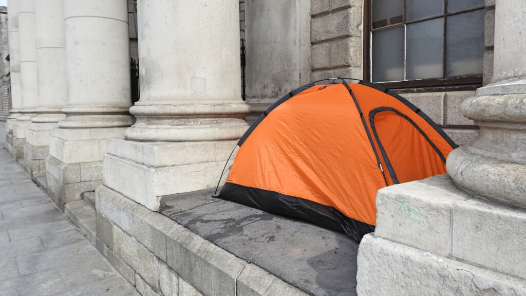 A camping tent set up in a public space.