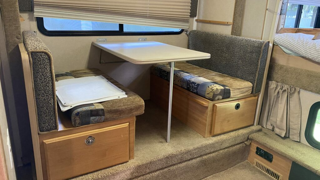 An rv dinette before being remodeled.