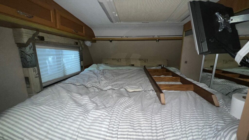 A bedroom inside a truck camper before being renovated.