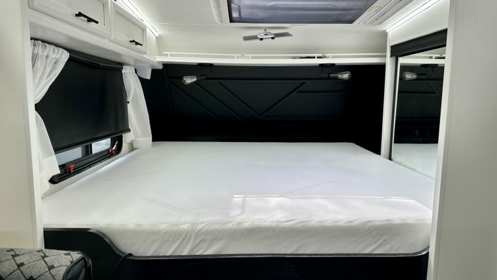 A bedroom inside a truck camper after being renovated.