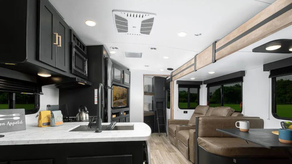 A living and kitchen area inside an Keystone Outback 291UBH.