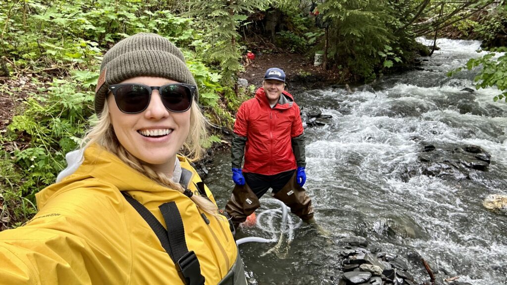 A couple taking a selfie smiling while panning for gold during Prospector John's Tour.