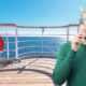 A man smoking on the cruise ship deck.