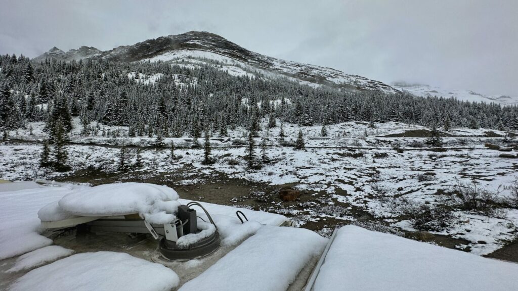 Picture from an RV roof showing the landscape around it covered in snow 