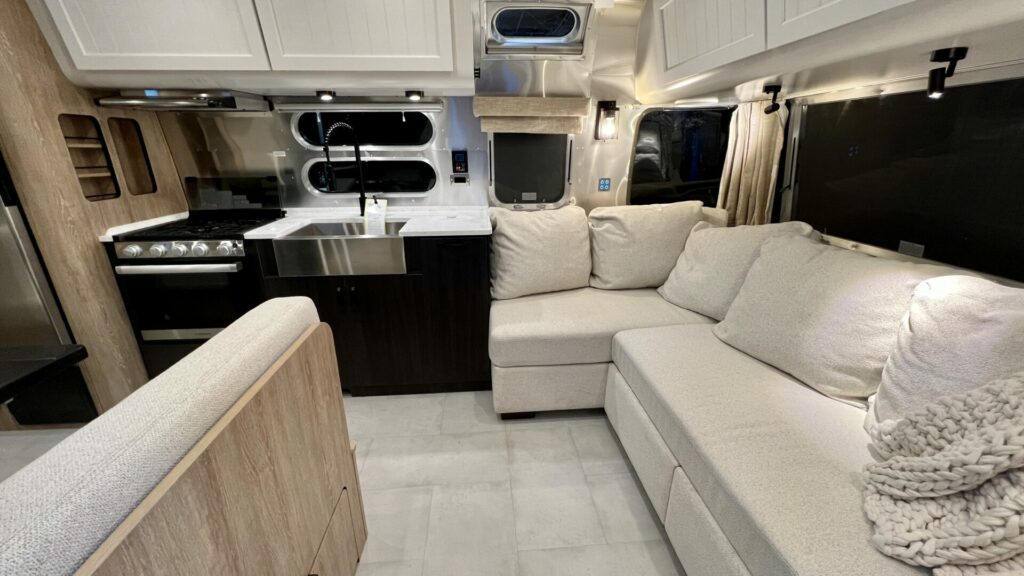 Interior shot of an Airstream kitchen and couch, one of the best travel trailer brands on the market 