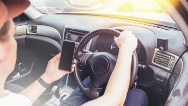 A person texting and driving.