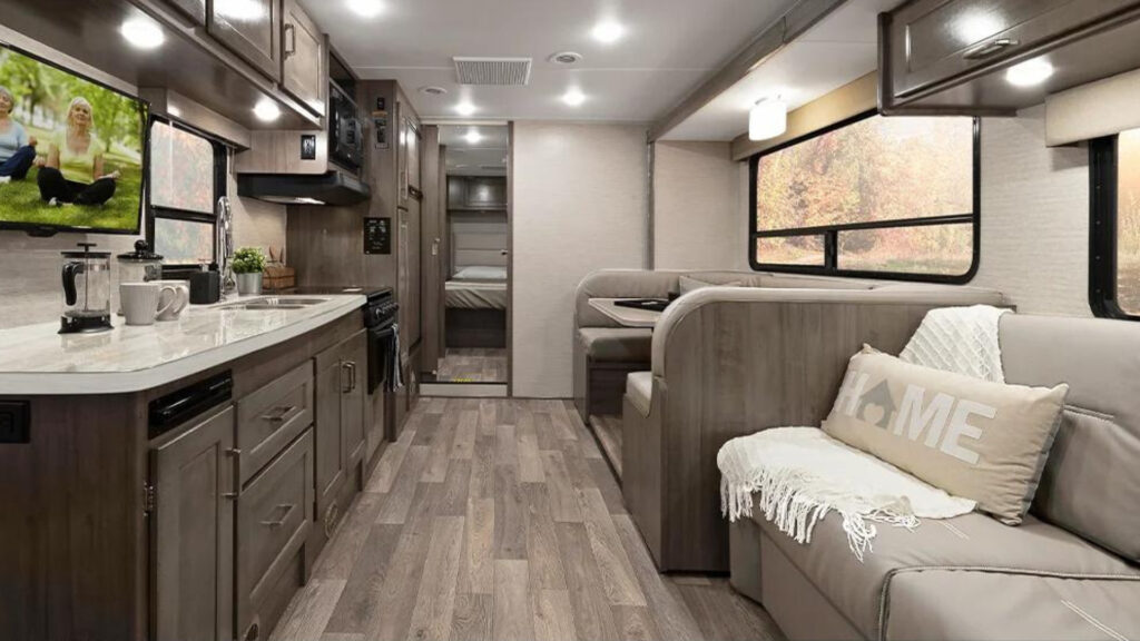 View of the living and kitchen area inside a Winnebago Minnie Winnie 31H.
