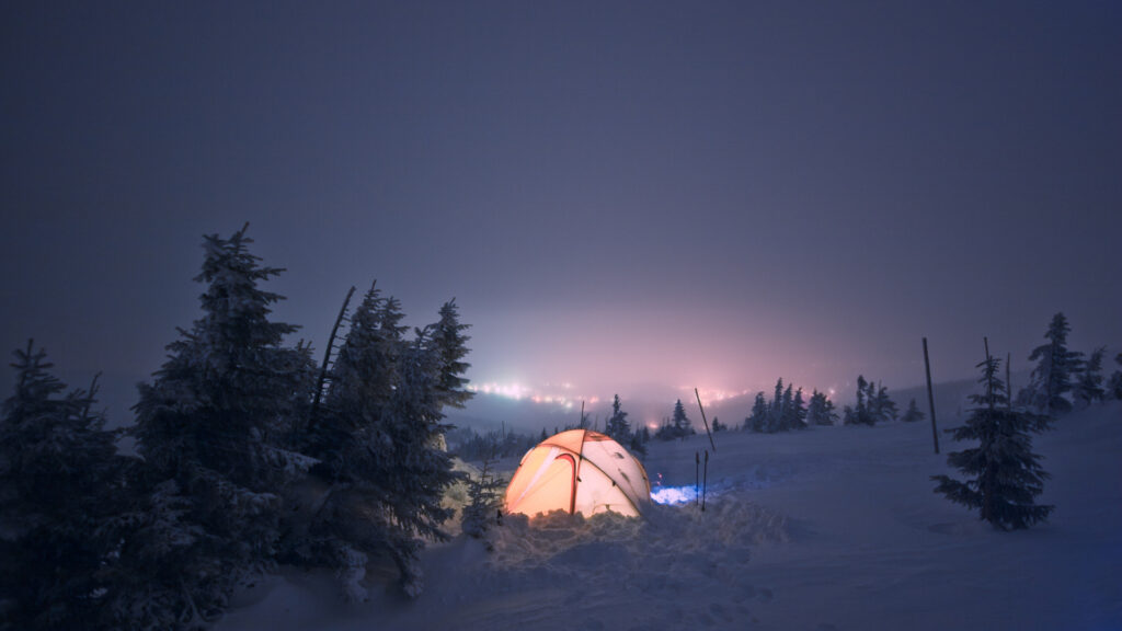 A winterized tent in the snow for cold weather camping.