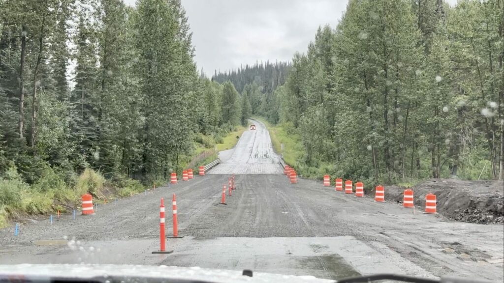 A gravel patch with construction cones on a rainy day on the Cassiar Highway. 