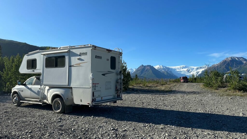 Truck Camper stopped on the McCarthy road enjoying the views of a glacier in the background