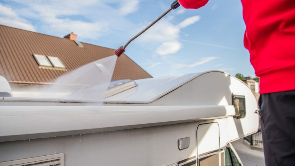 A man cleaning the roof of his RV.