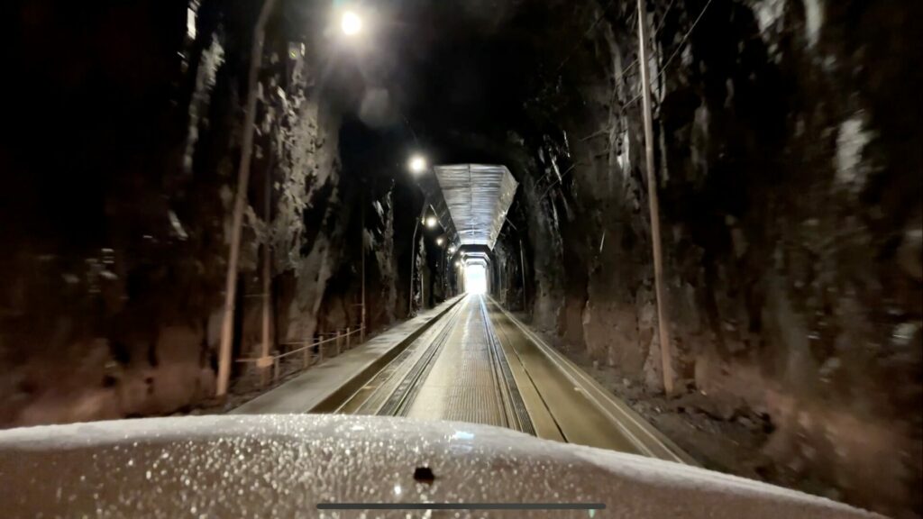 Interior shot of the Whittier Tunnel near the end showing the daylight at the end of the tunnel.
