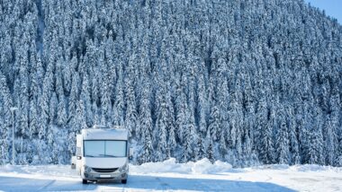 An RV in the mountains in the winter.