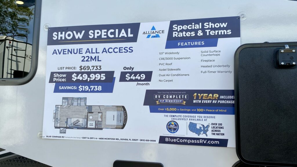A sign on an RV that shows special pricing for the RV show it is at. 