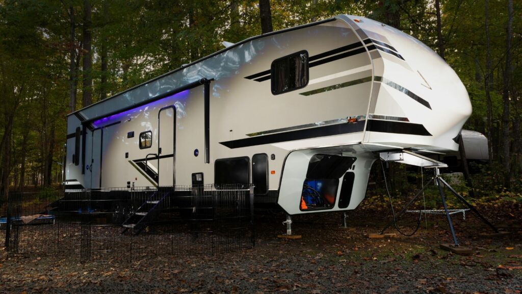 A large fifth wheel RV parked at a campsite.