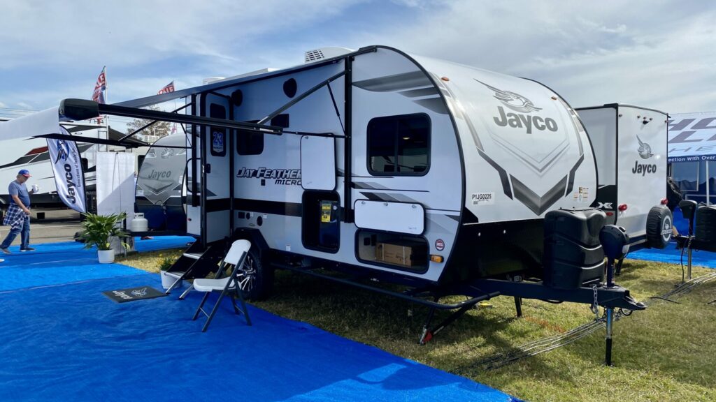 A small Jayco travel trailer parked at an RV show 