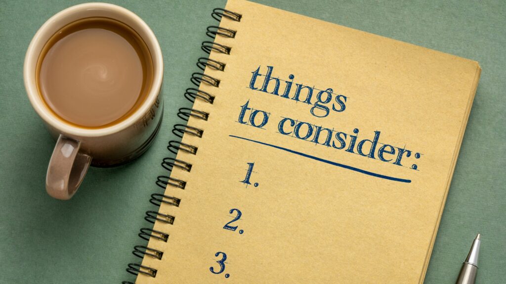 A notepad that says "things to consider" with one through three written out. There is a cup of coffee and a pen next to the pad. 